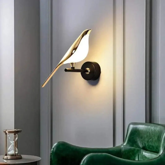 Modern bird-inspired wall light with gold acrylic finish and warm white LED