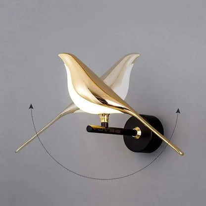Modern bird-inspired wall light with gold acrylic finish and warm white LED